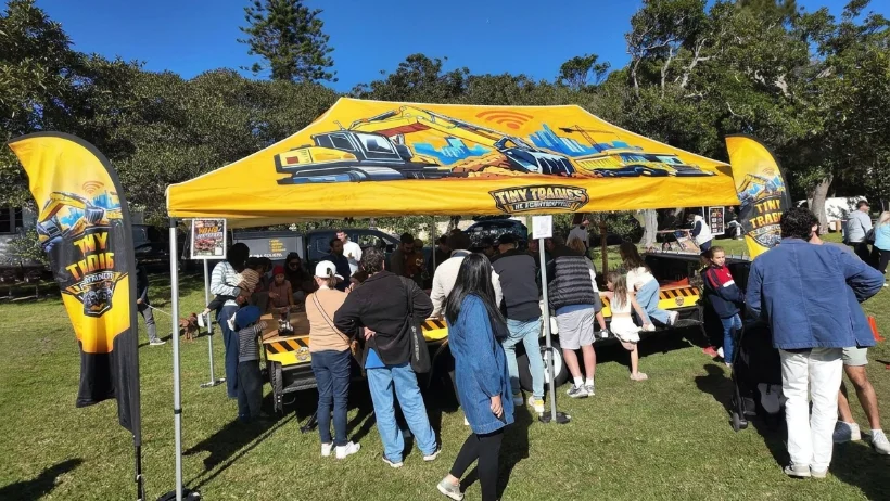 Tiny Tradies branded marquee at a live outdoor event